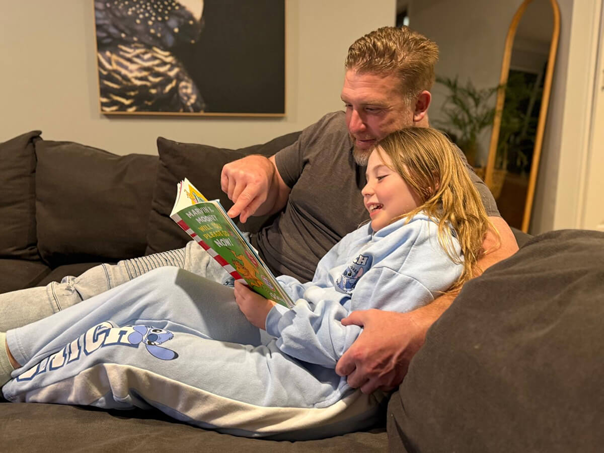 teen and father reading a book | Capital Smiles